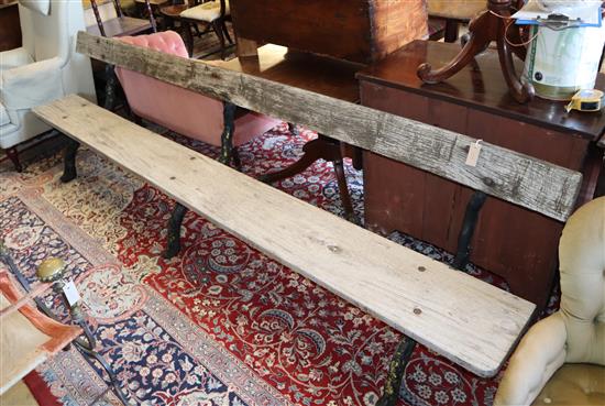 A large Victorian cast iron and wood slat garden bench, length 305cm, depth approx. 55cm, height 77cm